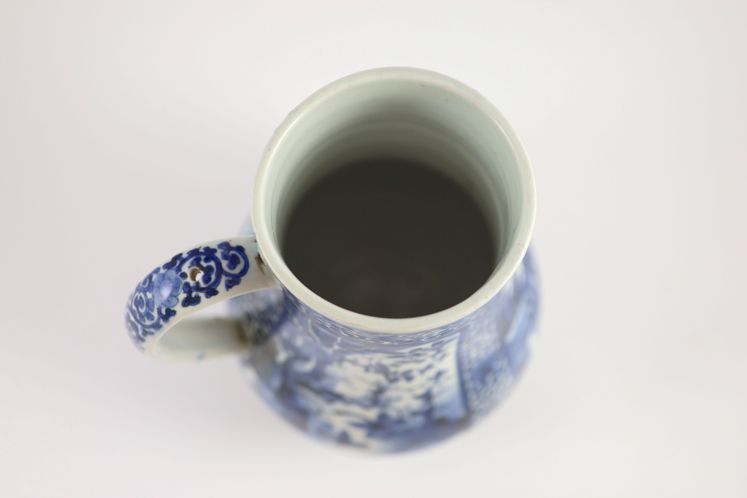 A Japanese Arita blue and white tankard, c.1700, 23.8 cm high